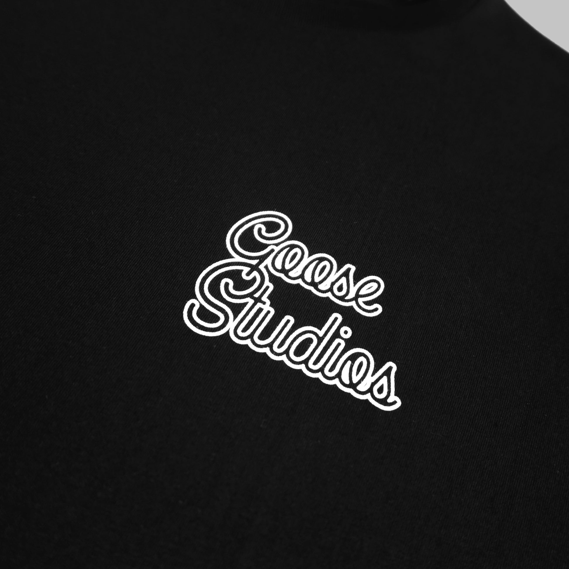 Close up of front of Black organic cotton T Shirt with white printed logo